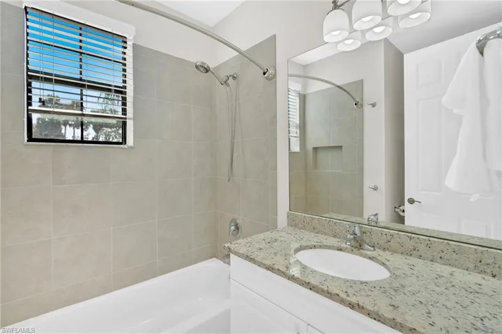 Bathroom featuring vanity and shower / tub combination