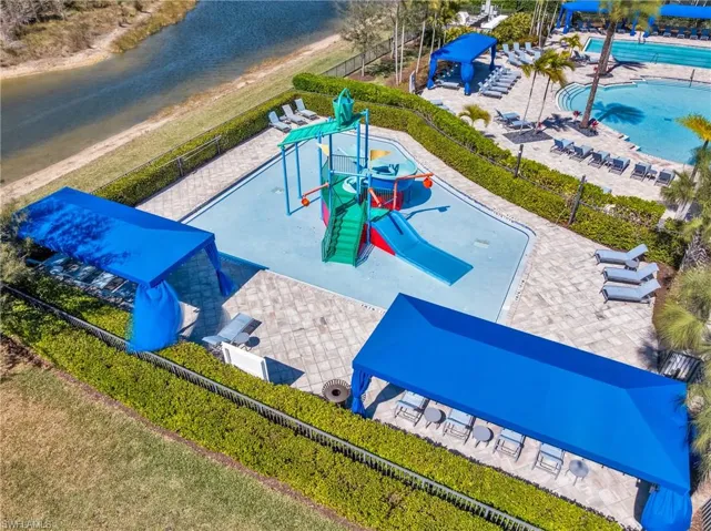 Drone / aerial view of a large body of water and a pool
