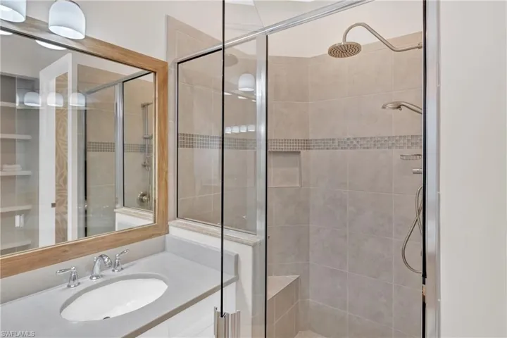 Bathroom with vanity and a shower stall