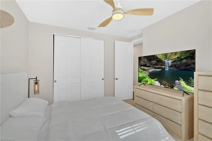 Bedroom with ceiling fan and a closet