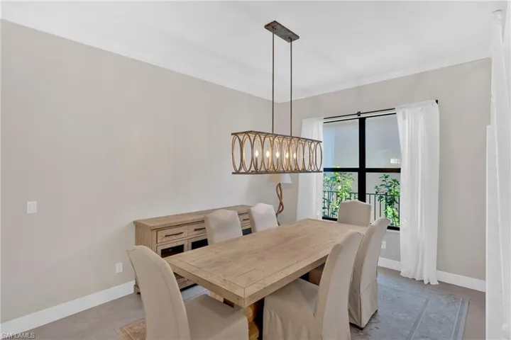 Dining room featuring ornamental molding and hanging lights