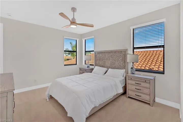 Bedroom featuring light carpet and ceiling fan