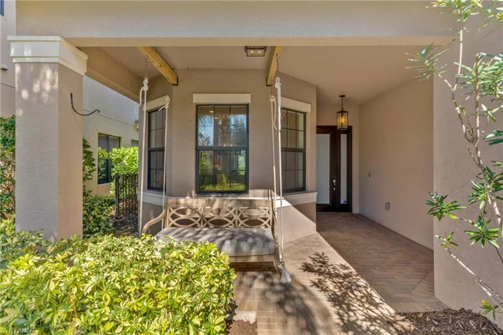 Entrance to property featuring stucco siding and a patio area