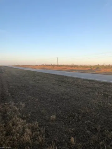 Yard at dusk featuring a rural view