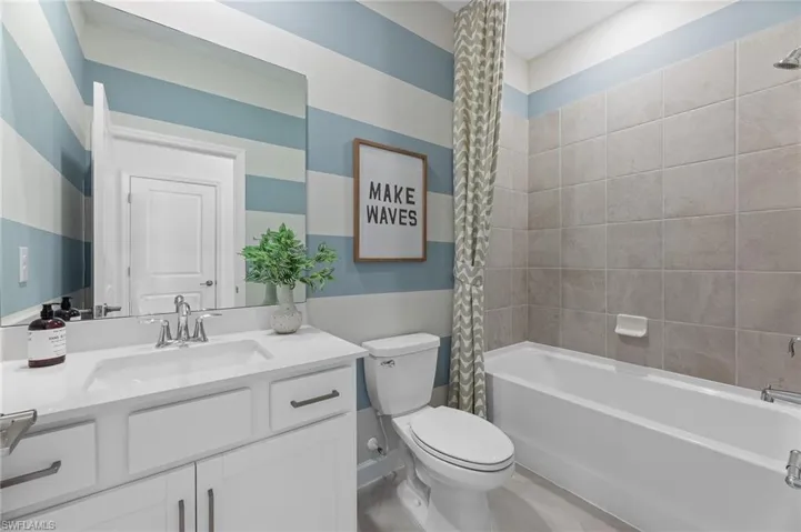 Full bathroom featuring vanity and shower / bath combo with shower curtain