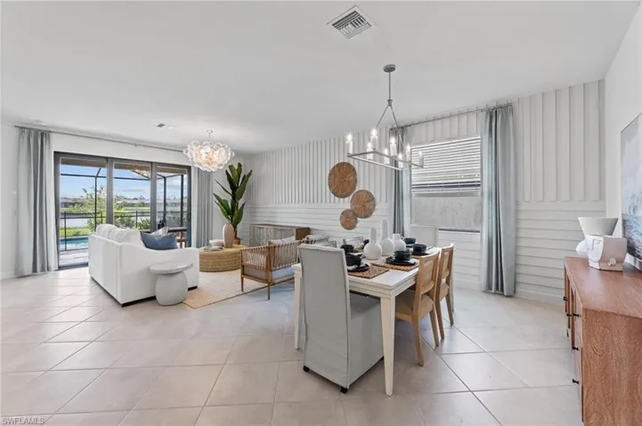 Dining space featuring a chandelier, healthy amount of natural light, and light tile patterned floors