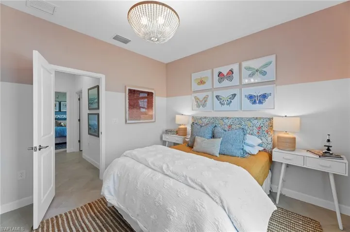 Bedroom featuring light tile patterned floors and a chandelier