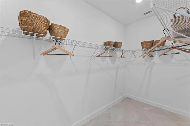 Walk in closet featuring light tile patterned flooring