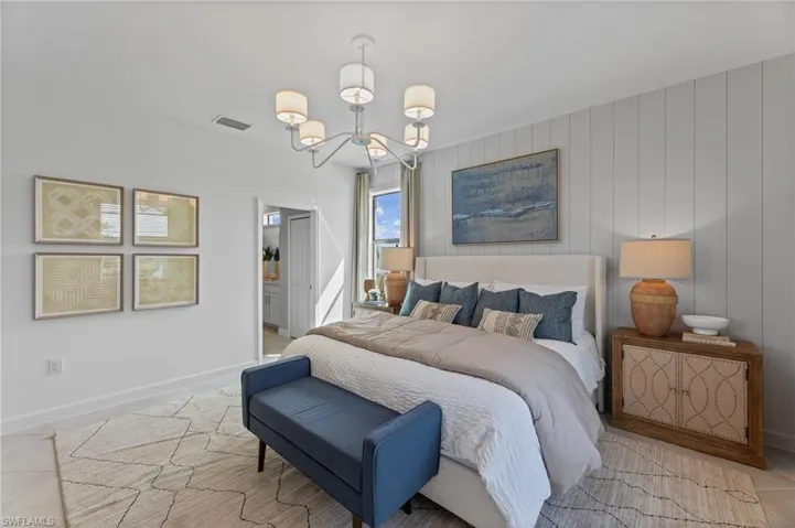 Bedroom featuring a chandelier and ensuite bathroom