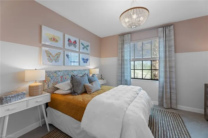 Tiled bedroom with multiple windows and a chandelier