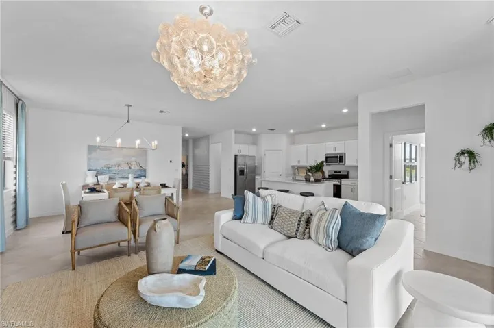Living area with a chandelier, plenty of natural light, and recessed lighting