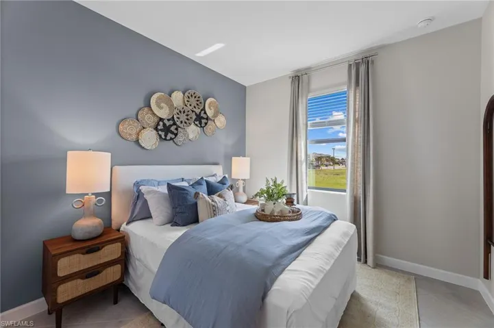 Bedroom featuring baseboards and light tile patterned flooring