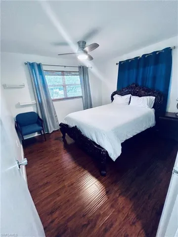 Bedroom featuring dark wood finished floors, ceiling fan, and a textured ceiling