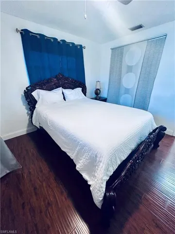 Bedroom featuring dark wood-type flooring and a ceiling fan