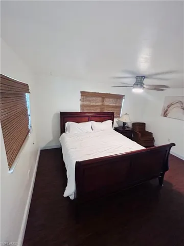 Bedroom featuring dark wood finished floors and ceiling fan