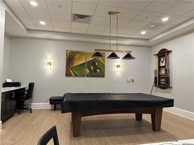 Community room with pool table, card tables &, an office area.