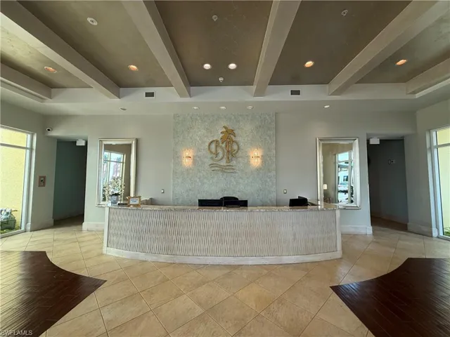 Reception area featuring beam ceiling and recessed lighting