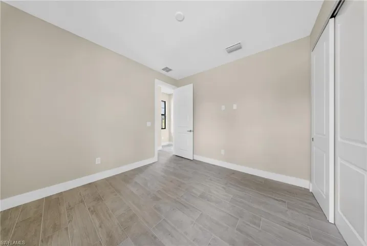 Neutral-toned walls complement wood-finish tile flooring