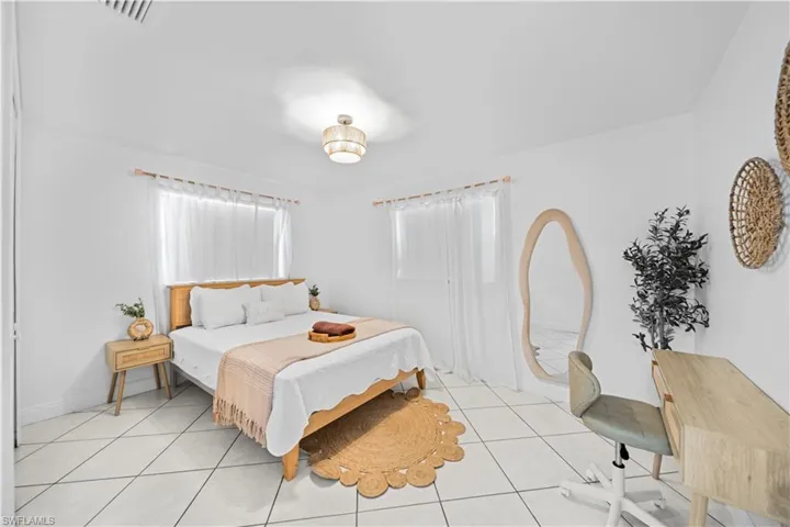 Bright room featuring white tile flooring and white walls