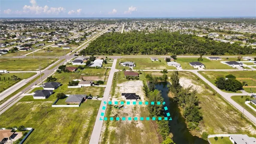 Birds eye view of property with a water view