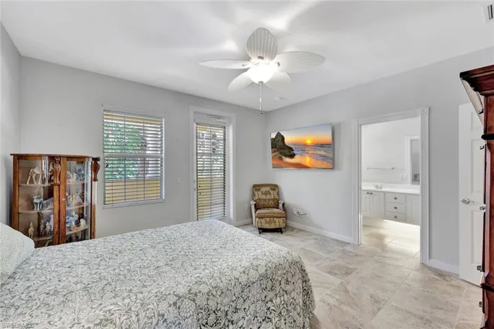 Retreat to your luxurious primary suite after a day well-spent poolside...