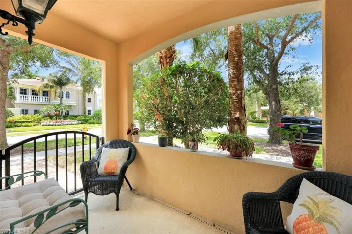 Guest bedroom patio features tropical views.