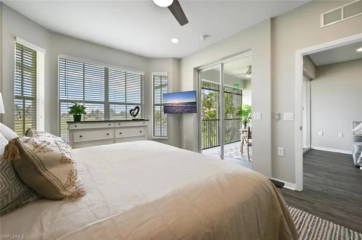 Bedroom featuring hardwood / wood-style floors, ceiling fan, and access to exterior