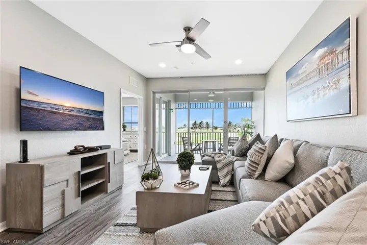 Living room featuring wood-type flooring and ceiling fan