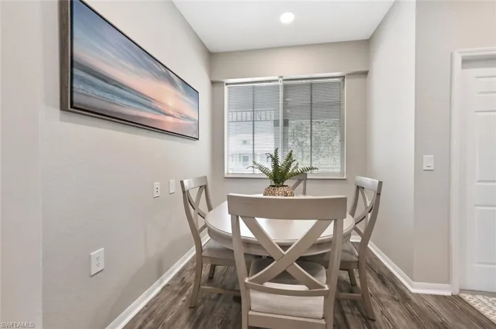 Dining area with dark hardwood / wood-style flooring