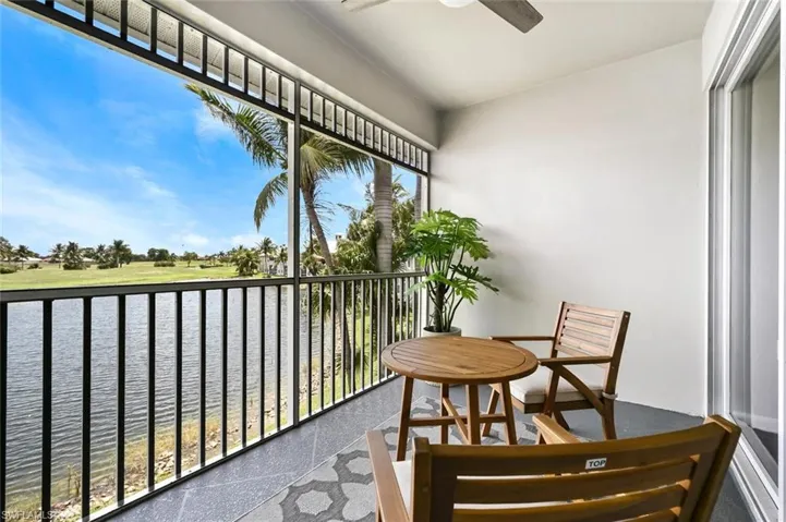 Sunroom / solarium featuring a water view and ceiling fan