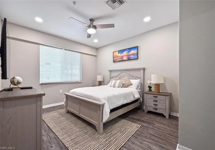 Bedroom featuring ceiling fan and dark hardwood / wood-style flooring
