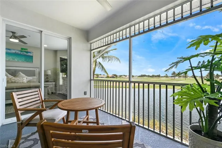 Sunroom / solarium featuring a water view and ceiling fan