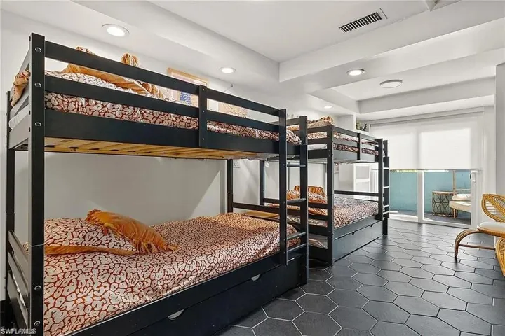 Bedroom featuring recessed lighting and dark tile patterned flooring