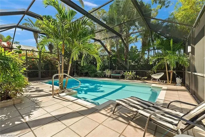 Outdoor pool with a patio area and a lanai