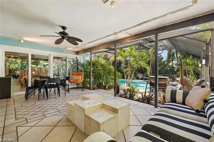 Sunroom / solarium featuring ceiling fan and track lighting
