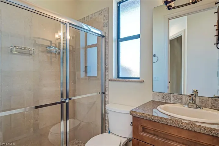 Bathroom with vanity and a shower stall