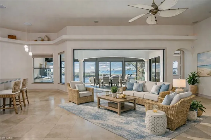 Living room with a ceiling fan and arched walkways