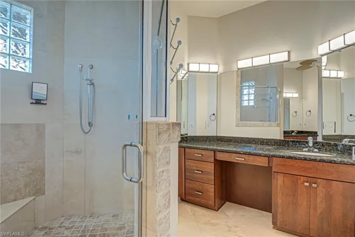 Full bath with vanity and a shower stall