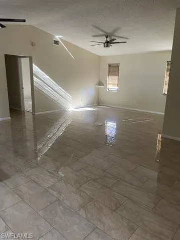 Spare room featuring a ceiling fan and a textured ceiling