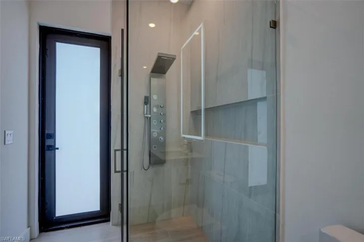 Bathroom featuring a shower with door