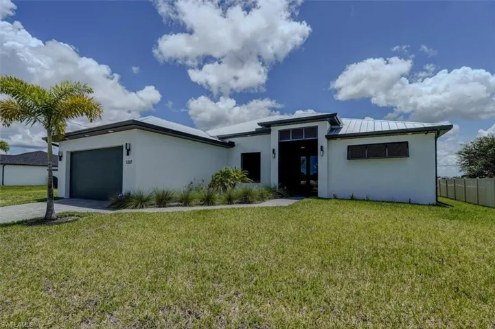 View of front facade with a garage and a front yard