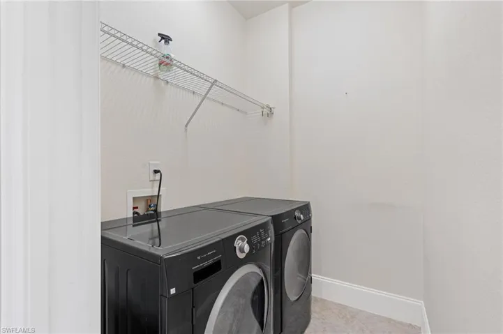 Laundry area featuring  tile patterned flooring, laundry area, and independent washer and dryer