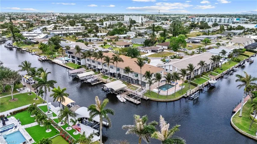 Birds eye view of property with a water view