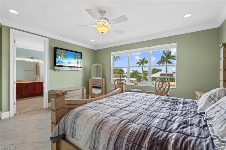 Bedroom featuring crown molding, light tile patterned flooring, and recessed lighting