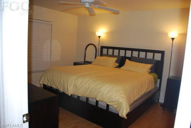Spacious master bedroom, walk in closet, window treatment, ceiling fan, wood plank flooring