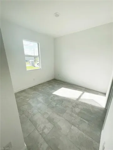 Spare room with tile patterned flooring