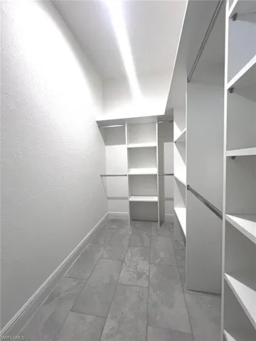 Spacious closet with tile patterned floors