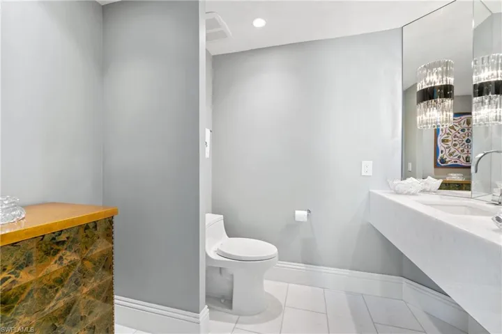 Bathroom with vanity, tile patterned flooring, and recessed lighting