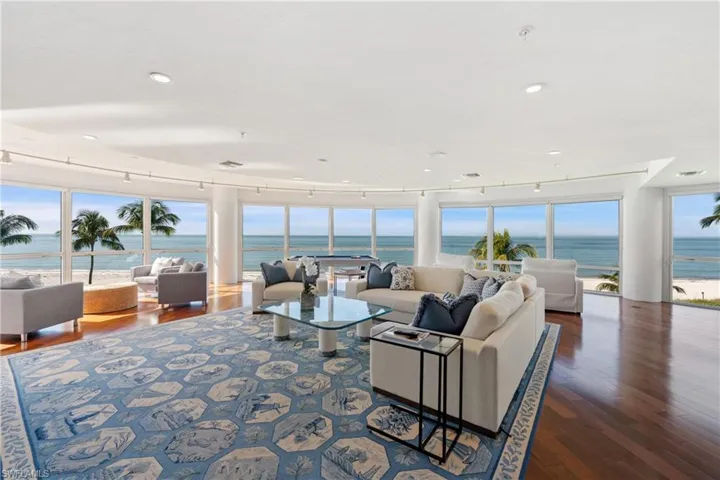 Living area featuring a water view, dark wood-style floors, healthy amount of natural light, and recessed lighting