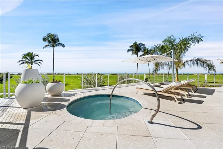 View of pool with an in-ground hot tub, a yard, and a patio area